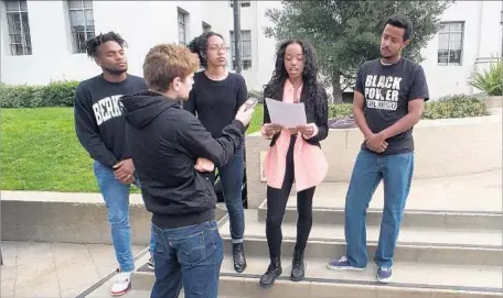  ?? Robin Abcarian Los Angeles Times ?? AJ MOULTRIE of the Black Student Union reads a statement last week demanding that UC Berkeley fully fund the Fannie Lou Hamer Black Resource Center. A university official said the center is funded, but the students said they have received nothing in writing.