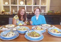  ??  ?? host Annalisa Burgos with Australian Amb. Amanda Gorely for a meal of appetizers, meat and pavlova Food Diplomacy