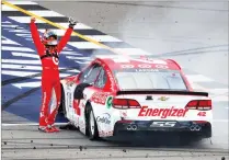  ?? AP PHOTO BY PAUL SANCYA ?? Kyle Larson celebrates winning a NASCAR Cup Series auto race in Brooklyn, Mich., Sunday.