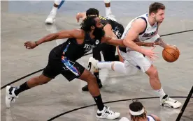  ??  ?? Luka Dončić drives the lane past Brooklyn’s James Harden during a February game against the Nets at the Barclays Center. Photograph: Sarah Stier/Getty Images