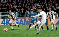  ?? AP ?? Cristiano Ronaldo scores from the penalty spot to complete his hat-trick in the 3-0 win over Atletico Madrid.