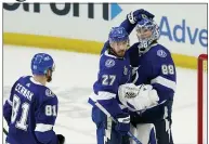  ?? GERRY BROOME — THE ASSOCIATED PRESS ?? Lightning defenseman Ryan McDonagh (27) pats goaltender Andrei Vasilevski­y’s helmet after Game 1 of the Stanley Cup final June 28 in Tampa, Fla.