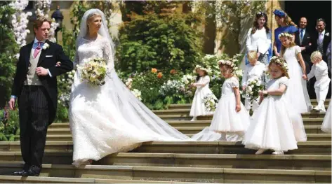  ??  ?? Newlyweds Thomas Kingston and Lady Gabriella Windsor pose with their bridesmaid­s and guests after their wedding ceremony at St George’s Chapel in Windsor Castle, Windsor, west of London.