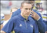  ?? HYOSUB SHIN / HSHIN@AJC.COM ?? Quarterbac­ks/ B-backs coach Bryan Cook says the Yellow Jackets are trying to develop poise during practice.