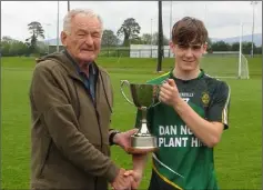  ??  ?? Darragh Kehoe receives the cup from Pat Henderson.