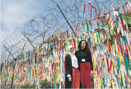  ?? Picture: EPA-EFE ?? TRUCE COLOURS.Foreign tourists next to ribbons in Imjingak park near the demilitari­sed zone in Paju, South Korea, yesterday. The Inter-Korean summit will take place at the truce village of Panmunjom on April 27. South Korea and the US may seek to sign...