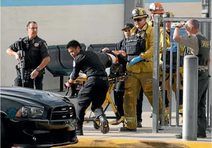  ?? AP ?? Emergency personnel remove an injured person following a shooting at Saugus High School in Santa Clarita, California.