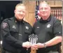  ?? TIMES photograph by Annette Beard ?? Pea Ridge Police Chief Lynn Hahn (right) presented a life-saving award to officer Justin Lawson at the Pea Ridge City Council meeting last week honoring Lawson.