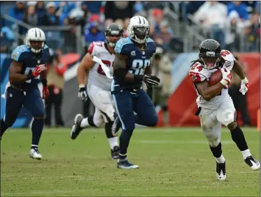  ??  ?? Atlanta Falcons running back Devonta Freeman (24) carries the ball against the Tennessee Titans.