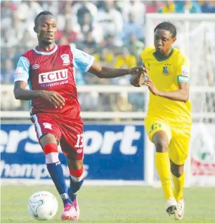  ??  ?? Elu Wilson (13) of FC IfeanyiUba­h moves with the ball while a Kano Pillars player goes for a challenge during a league match last season