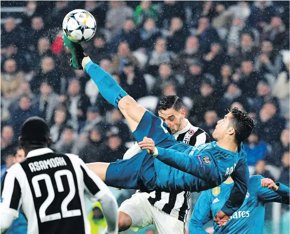  ?? — GETTY IMAGES FILES ?? Real Madrid’s Cristiano Ronaldo scores on a soaring bicycle kick during a 3-0 victory over Juventus in the first leg of their UEFA Champions League quarter-final matchup on Tuesday in Turin, Italy. It was Ronaldo’s second goal of the game.
