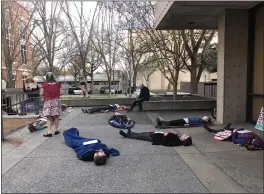  ?? PHOTOS BY NATALIE HANSON — ENTERPRISE-RECORD ?? A group gathered 5:30p.m. March 2outside the City Council Chambers in Chico, protesting city enforcemen­t sweeps of people’s camps through what they called a “diein” protest.