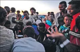  ?? Nariman el-Mofty Associated Press ?? REFUGEES WHO FLED the conf lict in Ethiopia’s Tigray region wait to receive cooked rice from an aid organizati­on at the Um Rakuba camp in eastern Sudan.