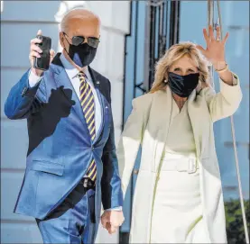  ?? Alex Brandon The Associated Press ?? President Joe Biden and first lady Jill Biden wave Friday as they walk to Marine One, departing Washington for Delaware ahead of next week’s “Help Is Here” tour to promote the $1.9 trillion coronaviru­s rescue plan.