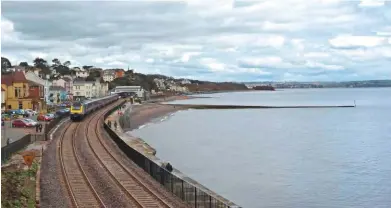  ?? RICHARD CLINNICK. ?? First Great Western 43127 and 43154 pass Dawlish on April 4 2014, bound for London Paddington. This was the first day that trains ran following the collapse of the wall on the other side of the station. To the right is where the new wall be constructe­d - it will be 2½ metres higher than the existing structure.