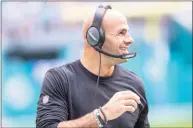  ?? Doug Murray / Associated Press ?? New York Jets coach Robert Saleh smiles as he watches from the sideline during an NFL game against the Miami Dolphins on Dec. 19 in Miami Gardens, Fla. Saleh cleared protocols and rejoined the Jets for practice on Wednesday.