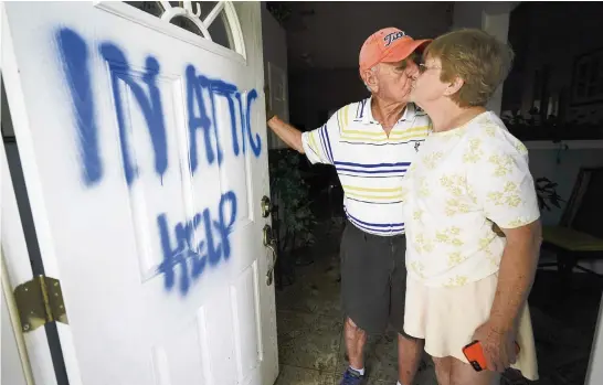  ?? GERALD HERBERT AP ?? Jack and Elaine Hulgan pose Thursday after riding out Hurricane Sally this week in their attic in Cantonment.