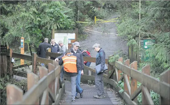  ?? WAYNE LEIDENFROS­T/PNG ?? Police and municipal workers block access to trails at the top of Riverside Drive in North Vancouver on Sunday after a landslide partially blocked the Seymour River. No one was injured in the incident and police say there is no danger to nearby homes.