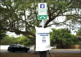  ?? ASSOCIATED PRESS ?? A parking area with charging stations for electric vehicles at a public park is seen Thursday in Orlando, Fla.