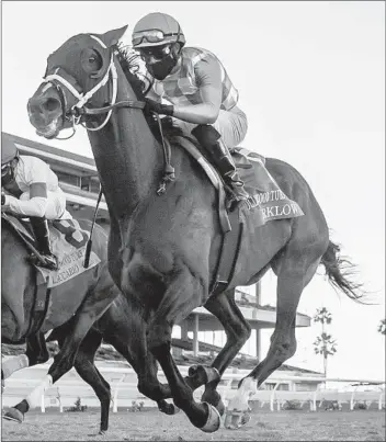  ?? BENOIT PHOTO ?? Arklow and jockey Joel Rosario score in the Grade II, $200,000 Hollywood Turf Cup on Friday at Del Mar.