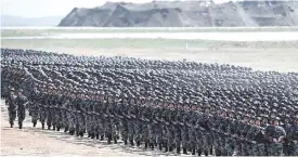  ??  ?? Chinese soldiers march in a military parade at the Zhurihe training base in China’s northern Inner Mongolia region. —AFP
‘Always follow the party’s orders’