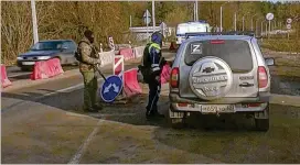  ?? HRU-RTR RUSSIAN TELEVISION VIA AP ?? Russian police officers check drivers’ documents near the border with Ukraine. Russia contends that a group of saboteurs from Ukraine crossed into its territory and attacked border villages, marking an escalation of a war that has dragged into its second year. A Ukrainian military official denied his nation’s involvemen­t.