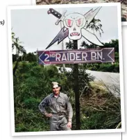  ??  ?? A Marine Raider corporal stands under the logo sign for the 2nd Marine Raider Division near Henderson Field after the Japanese were cleared off Guadalcana­l