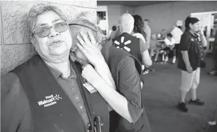  ?? MARK LAMBIE/EL PASO TIMES ?? Employees at an El Paso, Texas, Walmart react after a gunman killed at least 20 people and injured 26 more Saturday.