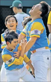  ??  ?? Hawaii’s Sean Yamaguchi (right) jumps in to celebrate with Zachary Won and Kory Chu after the Honolulu team beat South Korea 3-0 in the LLWS final.