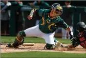  ?? RANDY VAZQUEZ — BAY AREA NEWS GROUP ?? The A's Austin Allen tags out the Giants' Kean Wong during a spring training game in 2020.