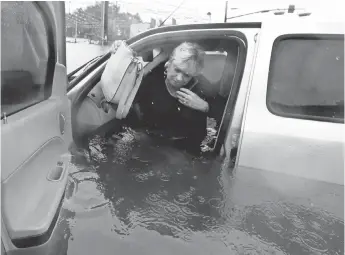  ?? LM OTERO, AP ?? Rhonda Worthingto­n’s vehicle is one of as many as 1 million in Texas damaged or destroyed by floods caused by Hurricane Harvey.