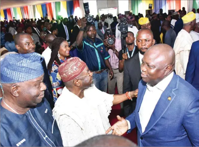  ??  ?? Ambode (right), with APC chieftains, Omooba Murphy Adetoro (2nd left) and Otunba Adetayo Oyemade (left), during the third quarter 2017 Town Hall meeting held at the Badore Ferry Terminal, Lagos