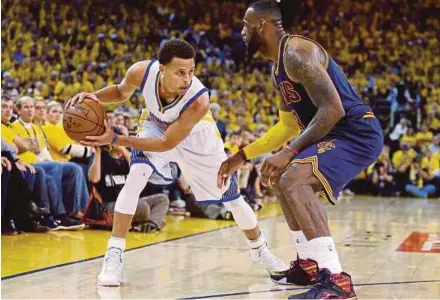  ?? AP PIC ?? Golden State Warriors’ Stephen Curry (left) is guarded by Cleveland Cavaliers’ LeBron James during the NBA Finals in Oakland on June 14, 2015.