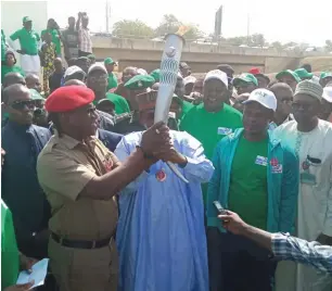  ??  ?? Minister of Sport Barrister Solomon Dalung (left) handing over the Torch of Unity to the FCT Minister Muhammed Bello at the Abuja City Gate, Thursday. Photo: Olusola Jide