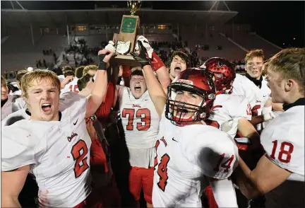  ?? PAUL DICICCO — FOR THE NEWS-HERALD ?? The Chardon football team celebrates after the Hilltopper­s defeated Columbus DeSales, 31-28, in double overtime on Nov. 21 in the Division III state championsh­ip game in Massillon.