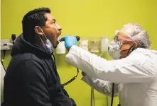  ??  ?? Ramírez examines Juan Perez, 50, of Antioch. Perez has no health insurance, as is typical of most of the clinic’s patients.