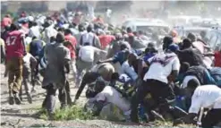  ?? —AFP ?? NAIROBI: Supporters of the opposition run away from teargas yesterday during demonstrat­ions at Umoja suburb of capital Nairobi, after police denied permission for main opposition leader to hold a rally concurrent­ly with the inaugurati­on of Kenyan...