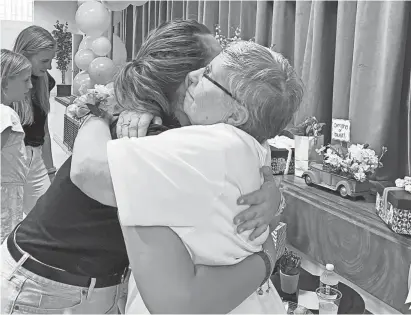  ?? TRESA BALDAS/DETROIT FREE PRESS ?? Sister Kathy Avery, 80, hugs one of her former students, Sophia Weiksnar, 19, at her farewell celebratio­n on Sunday at St. Clare of Montefalco Catholic School in Grosse Pointe Park. “For me, she got many doors to open,” Weiksnar said. “She’s an amazing person.”