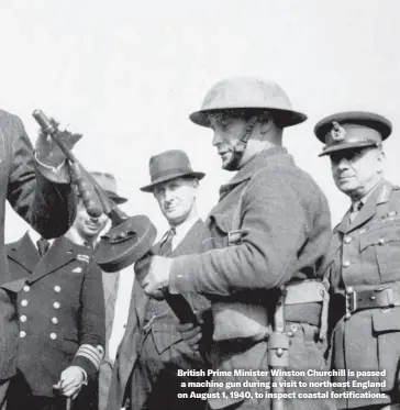  ?? ?? British Prime Minister Winston Churchill is passed a machine gun during a visit to northeast England on August 1, 1940, to inspect coastal fortificat­ions.