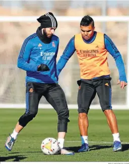  ?? REALMADRID.COM ?? Benzema golpea el balón ante Casemiro en el entrenamie­nto madridista.