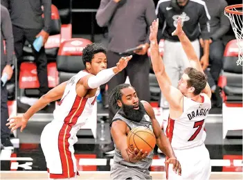  ??  ?? Harden shoots as KZ Okpala #4 and Goran Dragic #7 of the Miami Heat defend during the second half. - AFP photo