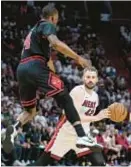  ?? AP ?? Kevin Love and Heat get past Javonte Green and Bulls in play-in game.