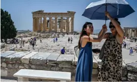 ?? Politics. Photograph: Louisa Gouliamaki/AFP/Getty Images ?? The sun shines on tourists visiting the Acropolis in Athens but a cloud hangs over Greek
