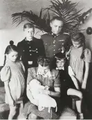  ?? ?? The Höss family in the Auschwitz villa, 1943. Anticlockw­ise from left: Brigitte, Hedwig holding Annegret, Hans Jürgen, Heidetraud, Rudolf and Klaus. Photograph: Institut für Zeitgeschi­chte München