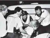  ?? PHOTO: JANE DAWBER ?? Victim . . . Chris Coles is loaded into an ambulance during the siege. Mr Coles did not survive.