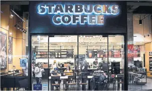  ?? GETTY IMAGES FILE PHOTO ?? Starbucks, which began testing delivery in Miami in September, will begin offering it in nearly a quarter of its more than 8,000 U.S. company-operated stores early next year.