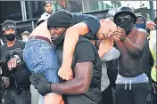  ?? REUTERS ?? Patrick Hutchinson, an anti-racism protester, carries an injured farright counter-protester to safety, in London, Britain.