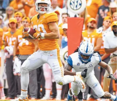  ?? STAFF FILE PHOTO BY ROBIN RUDD/TIMES FREE PRESS ?? Tennessee tight end Eli Wolf takes off after making a catch during a home game against Indiana State last September. Wolf was injured on the play and was unable to contribute as much as he hoped to last season, finishing with three catches for 48 yards.