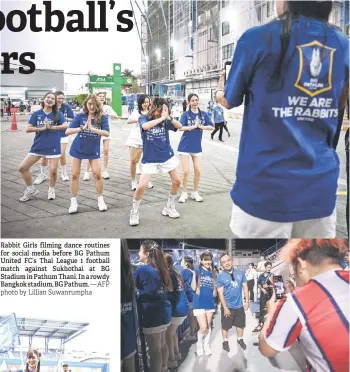  ?? — AFP photo by Lillian Suwanrumph­a ?? Rabbit Girls filming dance routines for social media before BG Pathum United FC’s Thai League 1 football match against Sukhothai at BG Stadium in Pathum Thani. In a rowdy Bangkok stadium, BG Pathum.
A Rabbit Girl having a photo taken with a football fan during BG Pathum United FC’s Thai League 1 football match against Sukhothai at BG Stadium in Pathum Thani.