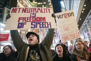  ?? MARY ALTAFFER — THE ASSOCIATED PRESS FILE ?? In this file photo, demonstrat­ors rally in support of net neutrality outside a Verizon store in New York. Brett Kavanaugh’s confirmati­on to the U.S. Supreme Court would put a spotlight on the dozens of federal cases pitting the Trump administra­tion against Democratic-leaning states, on issues including auto emission standards, immigratio­n and a freeflowin­g internet.